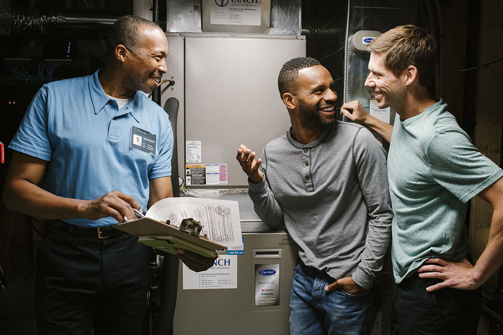 Homeowners receiving advice about their heat pump from a contractor