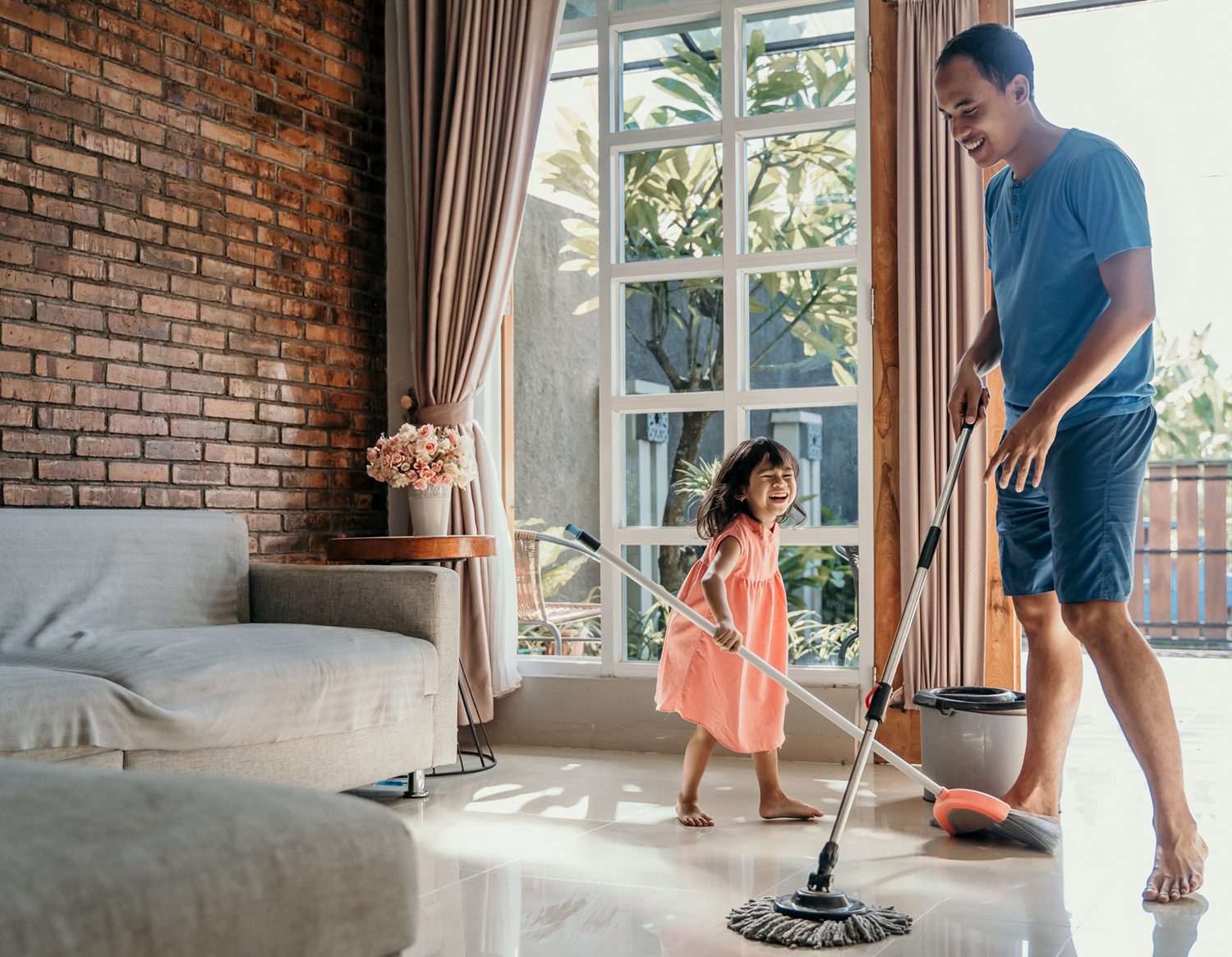 father and daughter moping the floor