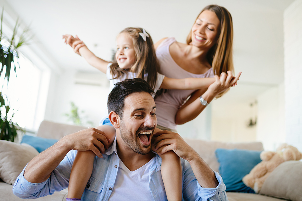 Happy family playing in living room