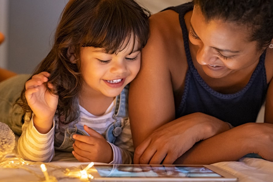 Mother and daughter watching movie on a tablet
